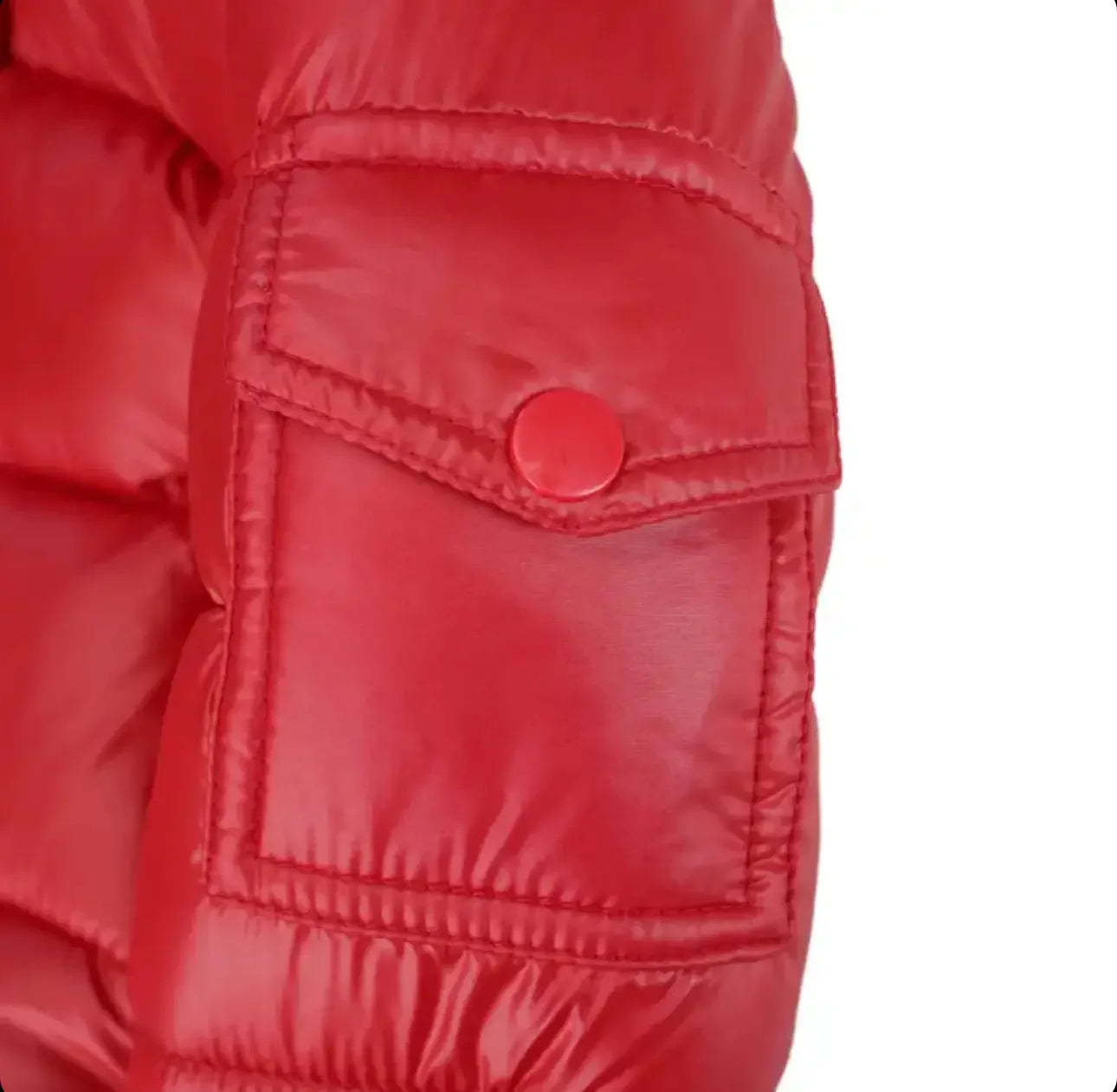 Close-up of red quilted puffer jacket sleeve with snap button pocket detail