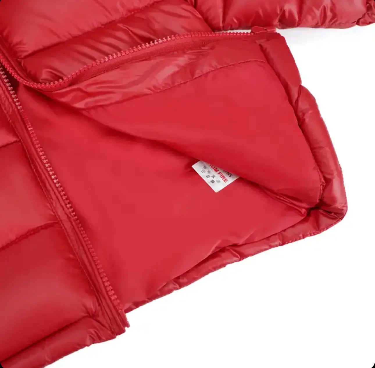 Close-up of red puffer jacket zipper and interior lining with care label visible