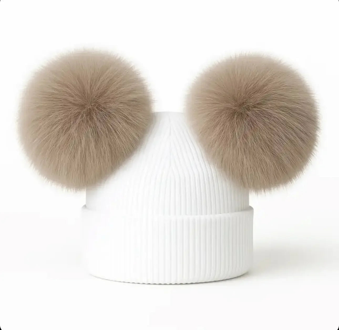 White ribbed knit winter beanie with two large beige faux fur pom poms