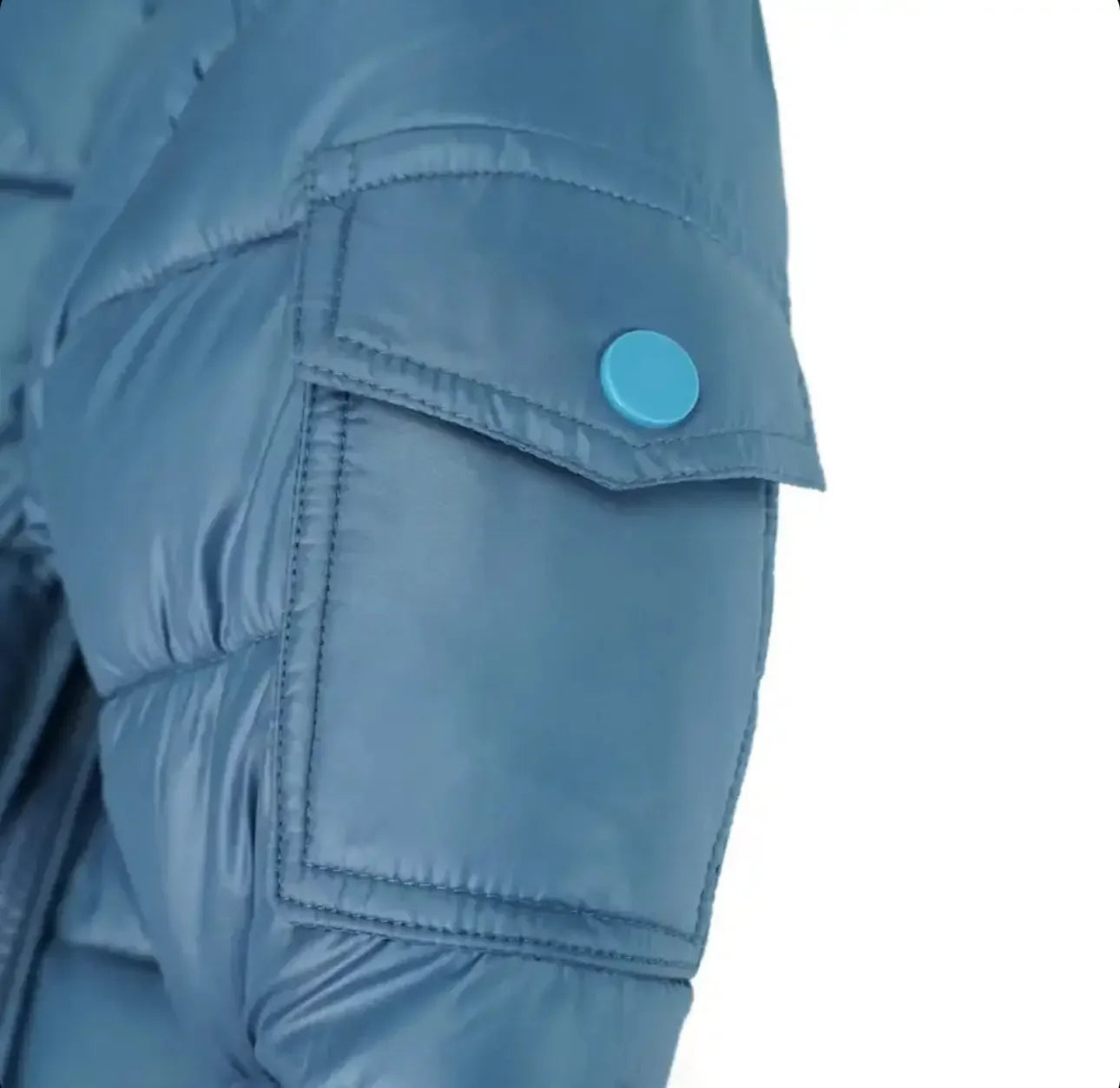 Close-up of blue puffer jacket sleeve with flap pocket and blue snap button