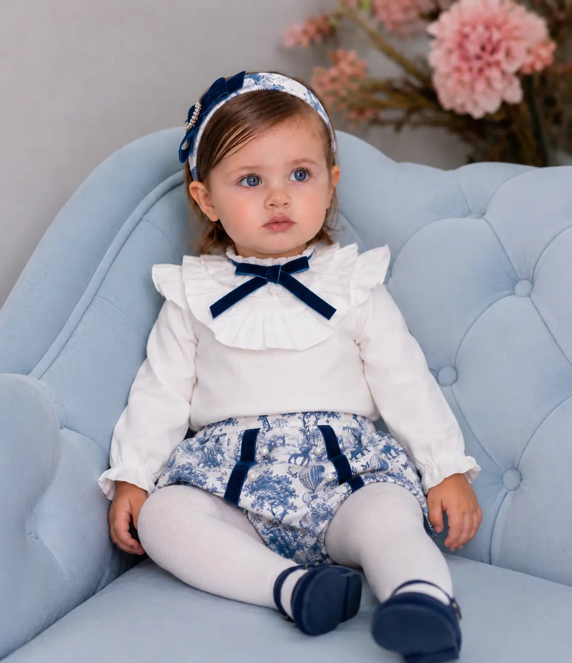 Shop the AW26 Rochy baby girls blue toile jam pant set with ivory frill blouse, navy velvet details and adjustable waist. Sizes 3M–4Y.