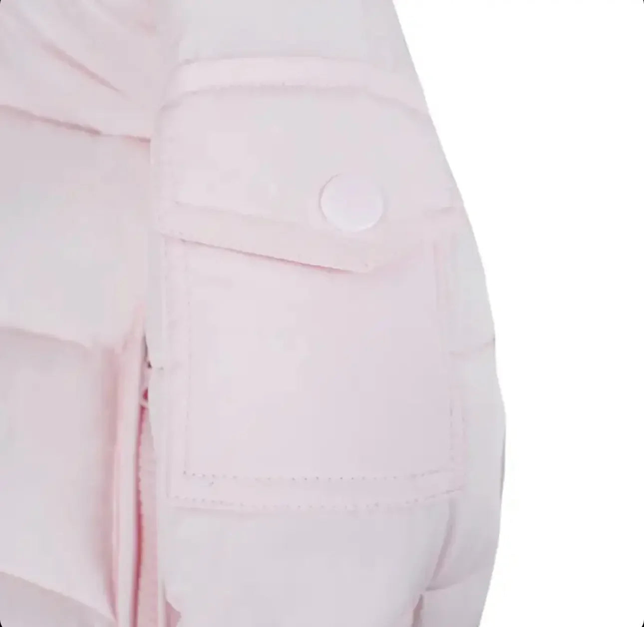 Close-up of pale pink padded jacket sleeve with snap-button pocket detail