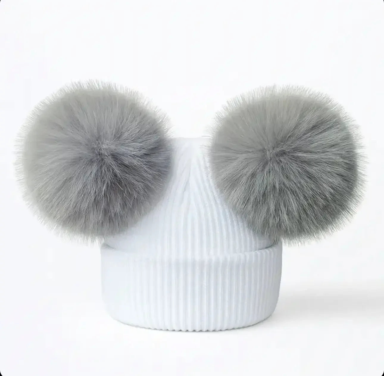 White ribbed knit beanie with two large gray faux fur pom poms on top
