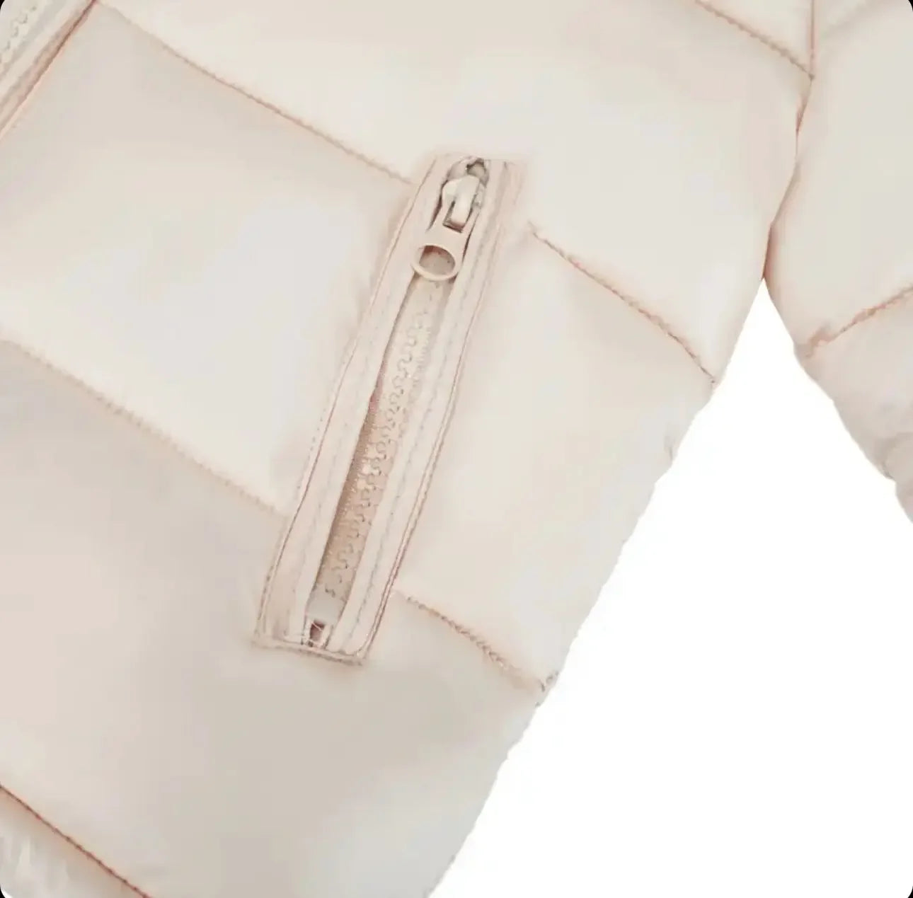Close-up of a beige quilted puffer jacket with a zipper pocket on the sleeve