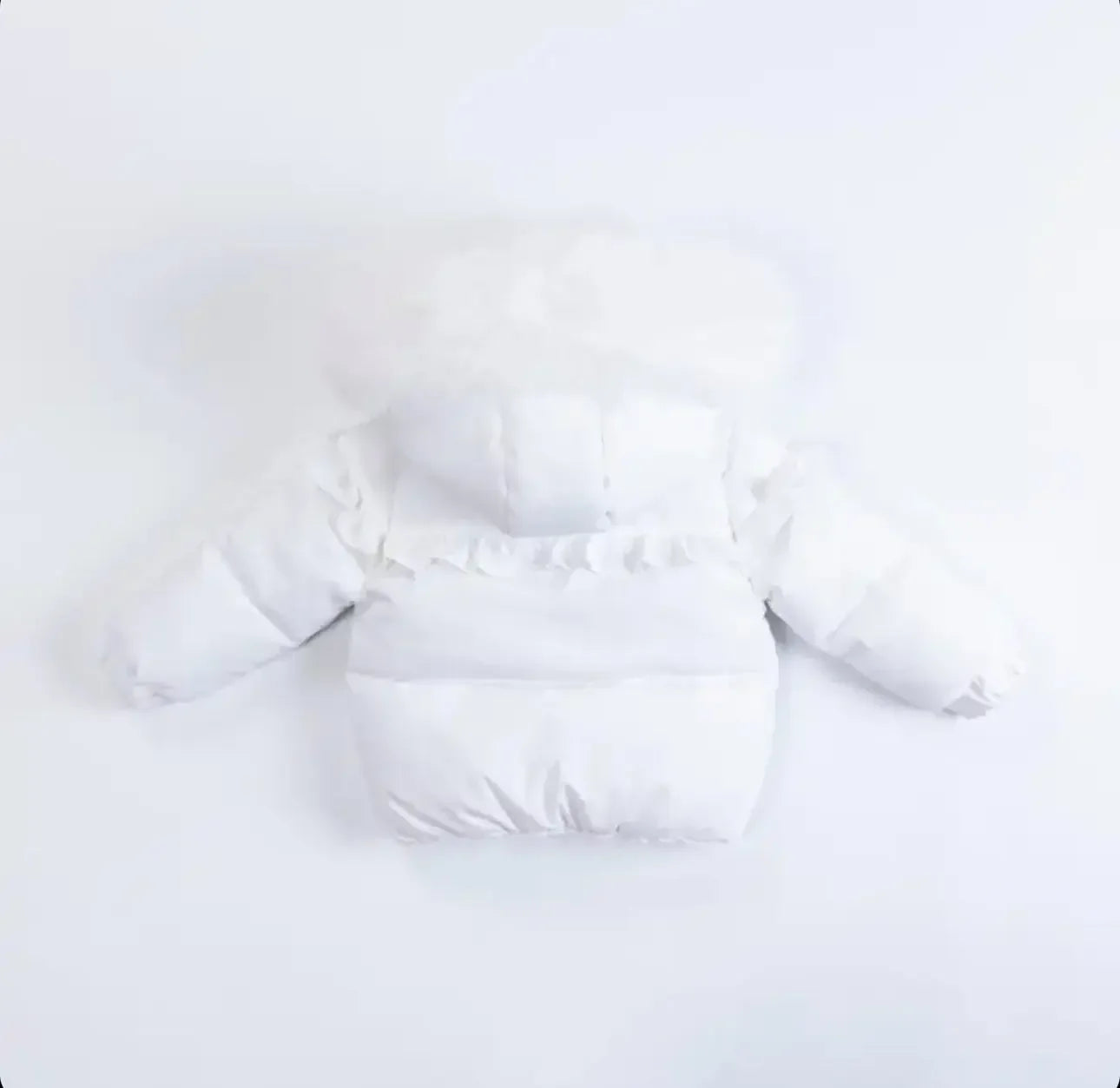 White baby puffer jacket with hood and ruffle detail on back isolated on white