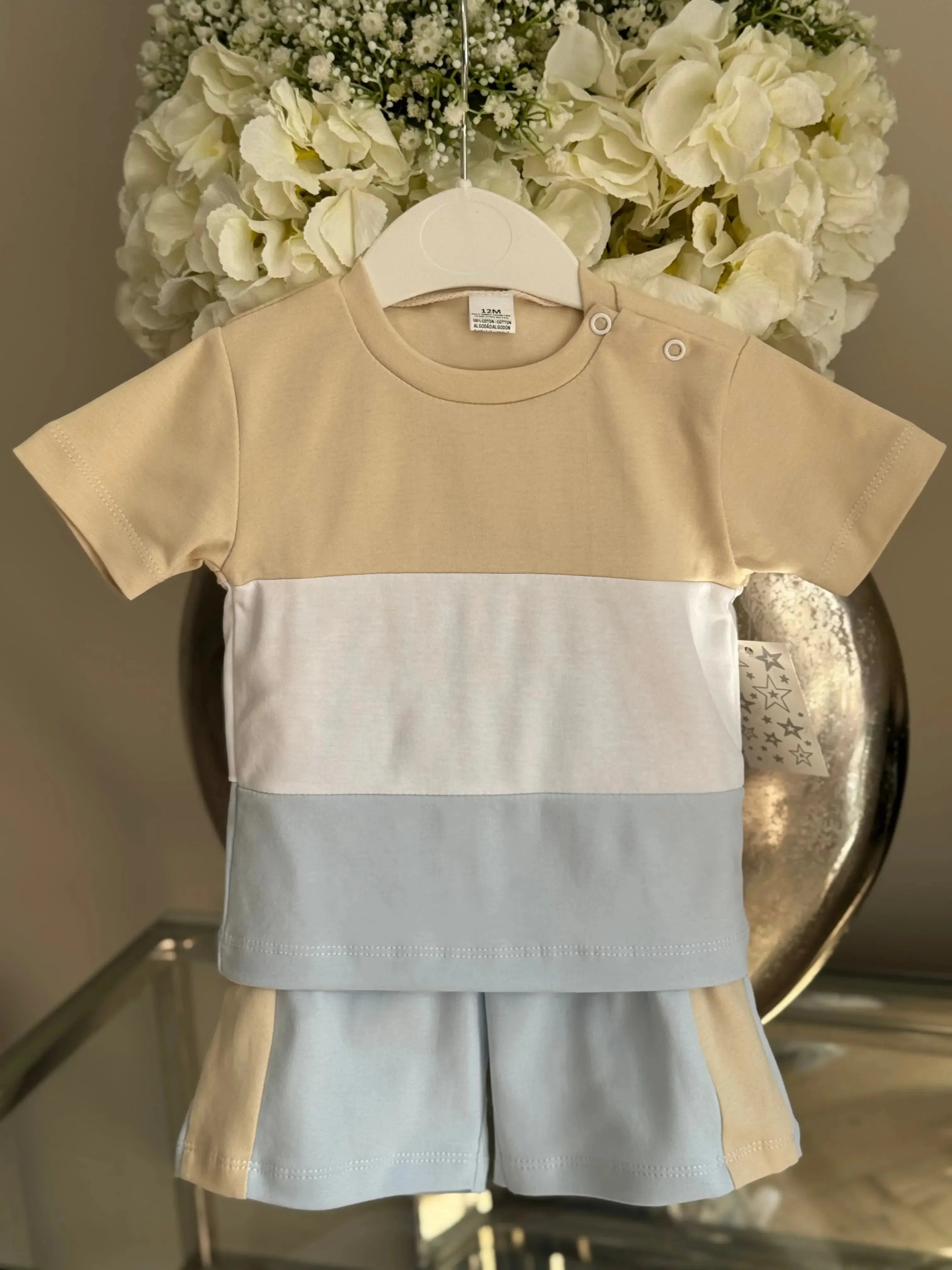 Color block baby boy summer outfit with beige, white, and light blue short sleeve shirt and matching shorts
