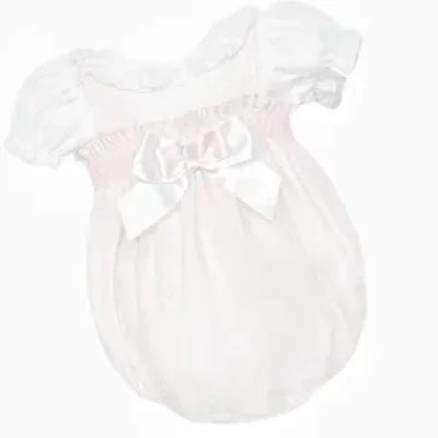 Dainty pink Spanish baby romper with puff sleeves and large satin bow on front