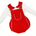 Red baby romper with white piping over white long-sleeve shirt, red Peter Pan collar