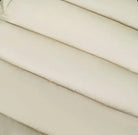 Close-up of beige textured stitched fabric with horizontal padded seams