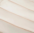Close-up of beige quilted fabric with horizontal padded stitching