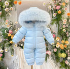 Light blue baby winter snowsuit with fur-lined hood displayed amidst colorful floral background
