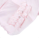 Close-up of light pink baby romper with ruffles and pearl embellishments on front