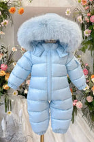 Light blue puffer baby snowsuit with large fluffy hood surrounded by colorful flowers