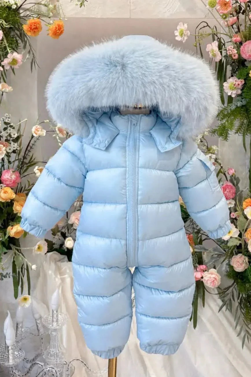 Light blue puffer baby snowsuit with large fluffy hood surrounded by colorful flowers