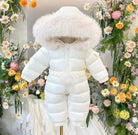 White puffer baby snowsuit with fur-trimmed hood displayed against floral background