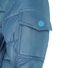 Close-up of blue puffer jacket sleeve with flap pocket and blue snap button