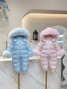Blue and pink fluffy hooded baby winter snowsuits displayed on mannequins indoors