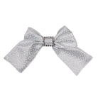 Silver girls' hair bow with delicate glitter pattern and rhinestone buckle center