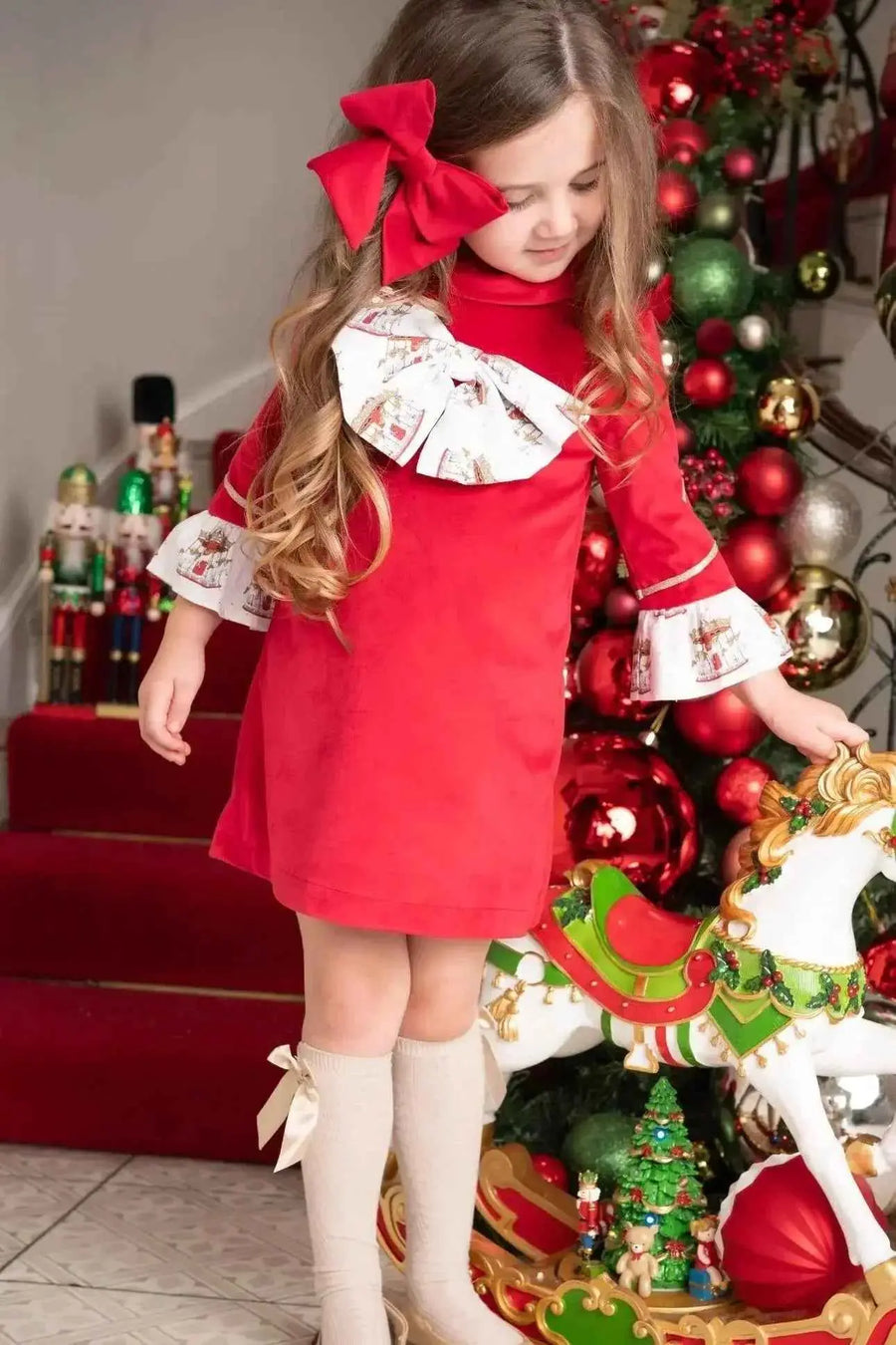 AW26 Babine Girls Red Velvet Carousel Dress, red with ruffled white collar and cuffs, available in sizes 2-12 years.
