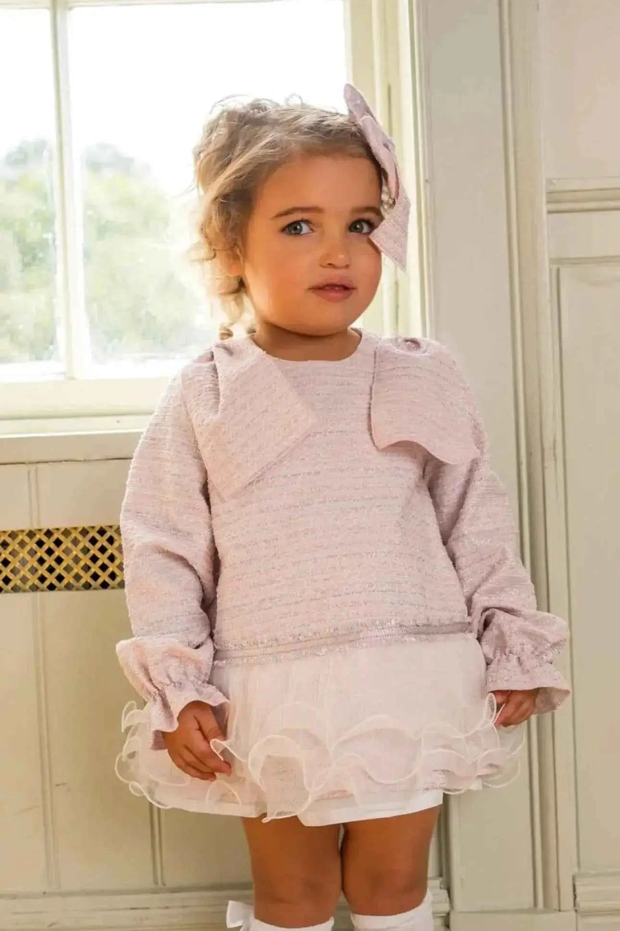 AW26 Naxos Baby Girls Pink Tweed Dress with long sleeves and ruffled hem, available in sizes 3M to 6Y.