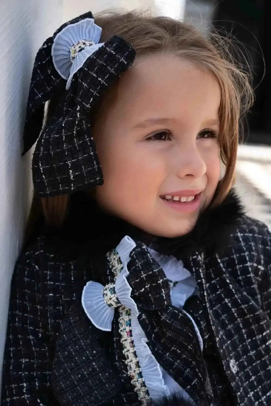 AW26 Naxos Girls Black Tweed Blazer and Skirt Set in black, available in sizes 4-14 years, featuring a classic design with a collar.