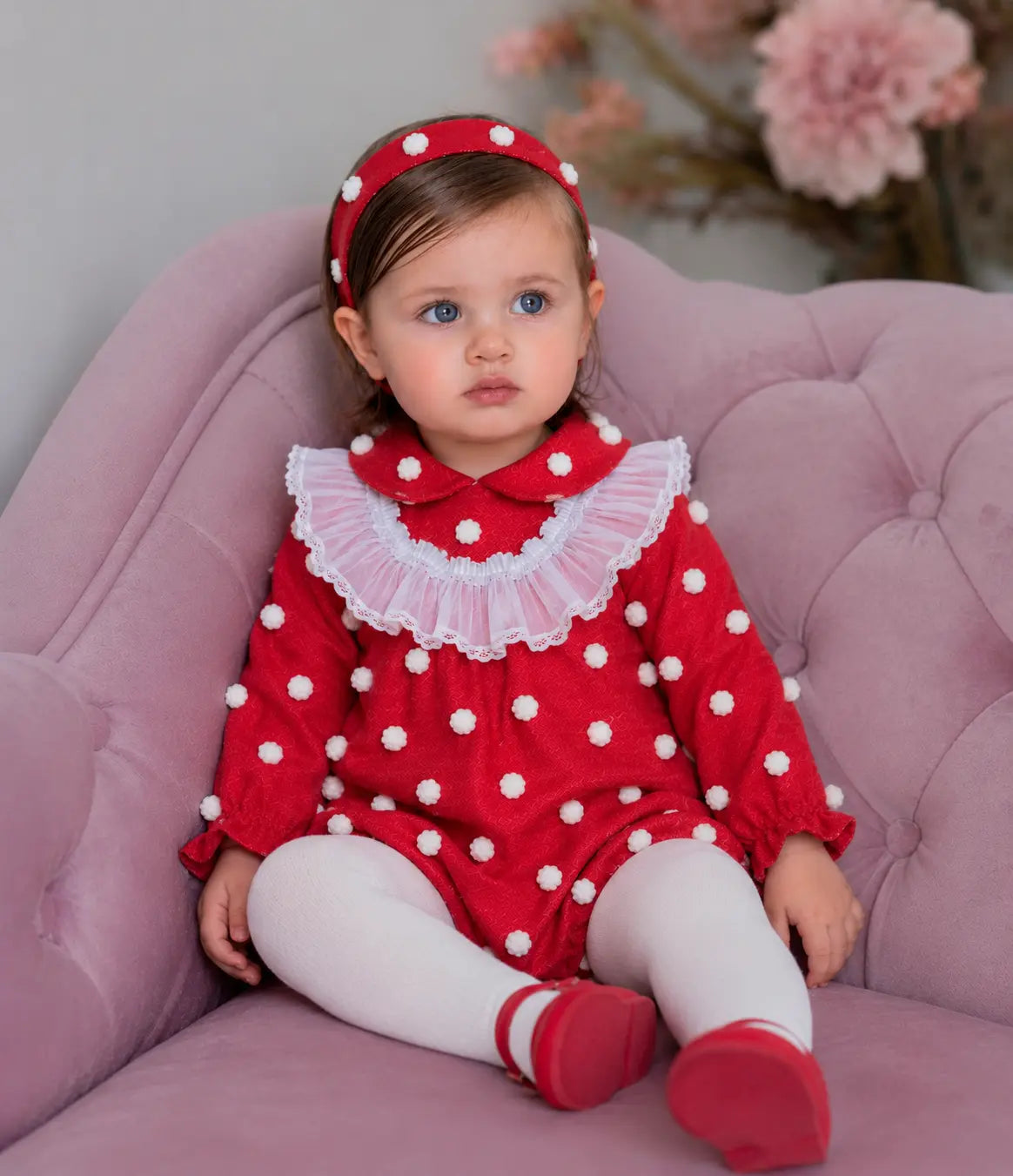 AW26 Rochy baby girls red romper with textured 3D white spot detailing and white sheer ruffle bib, sizes 3 months to 4 years