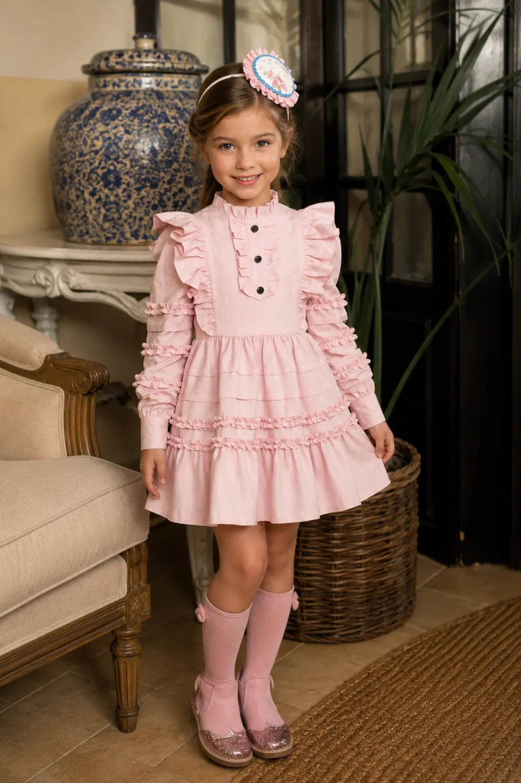 AW26 Rochy girls pink ruffle tiered dress with high frill neck, statement shoulders and long sleeves, sizes 4 to 10 years