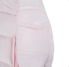 Close-up of pale pink padded jacket sleeve with snap-button pocket detail
