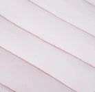 Close-up of soft, white, horizontally quilted fabric texture