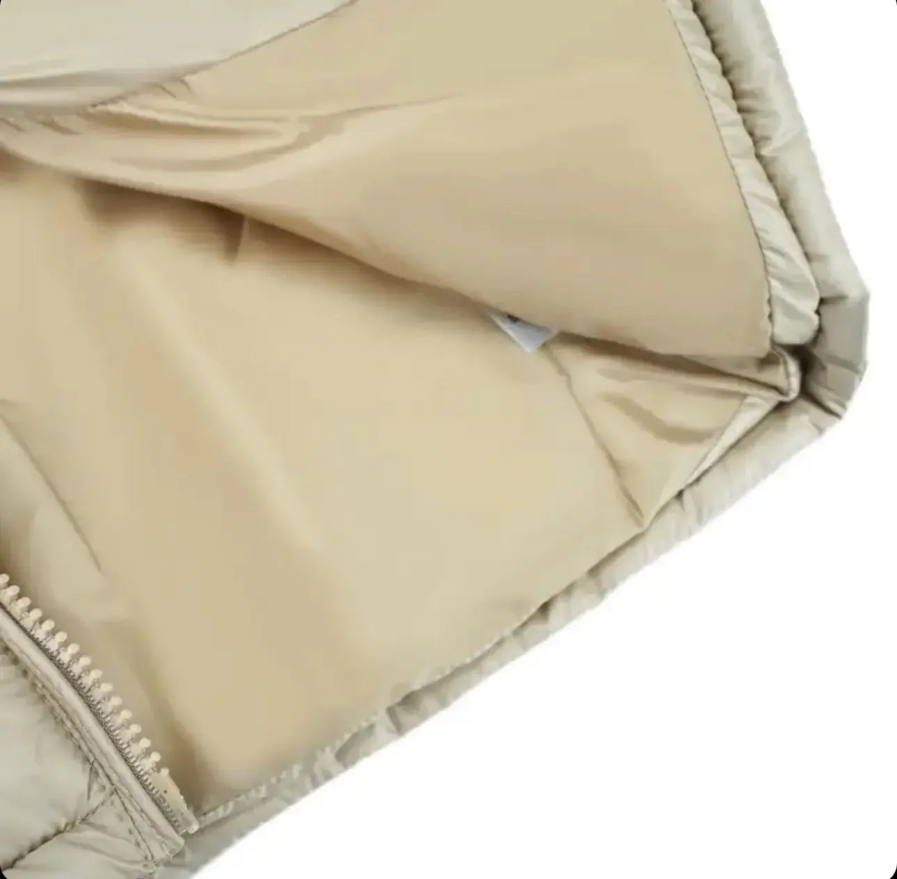 Close-up of beige puffer jacket zipper and smooth lining fabric detail