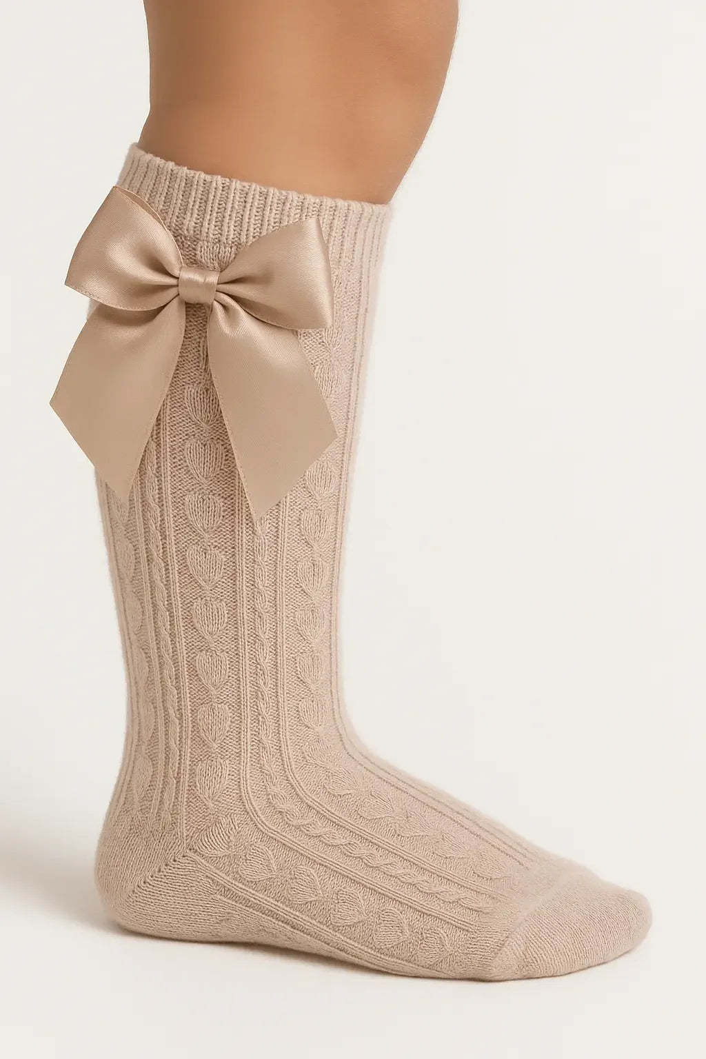 Beige knitted knee-high sock with cable pattern and large satin bow detail