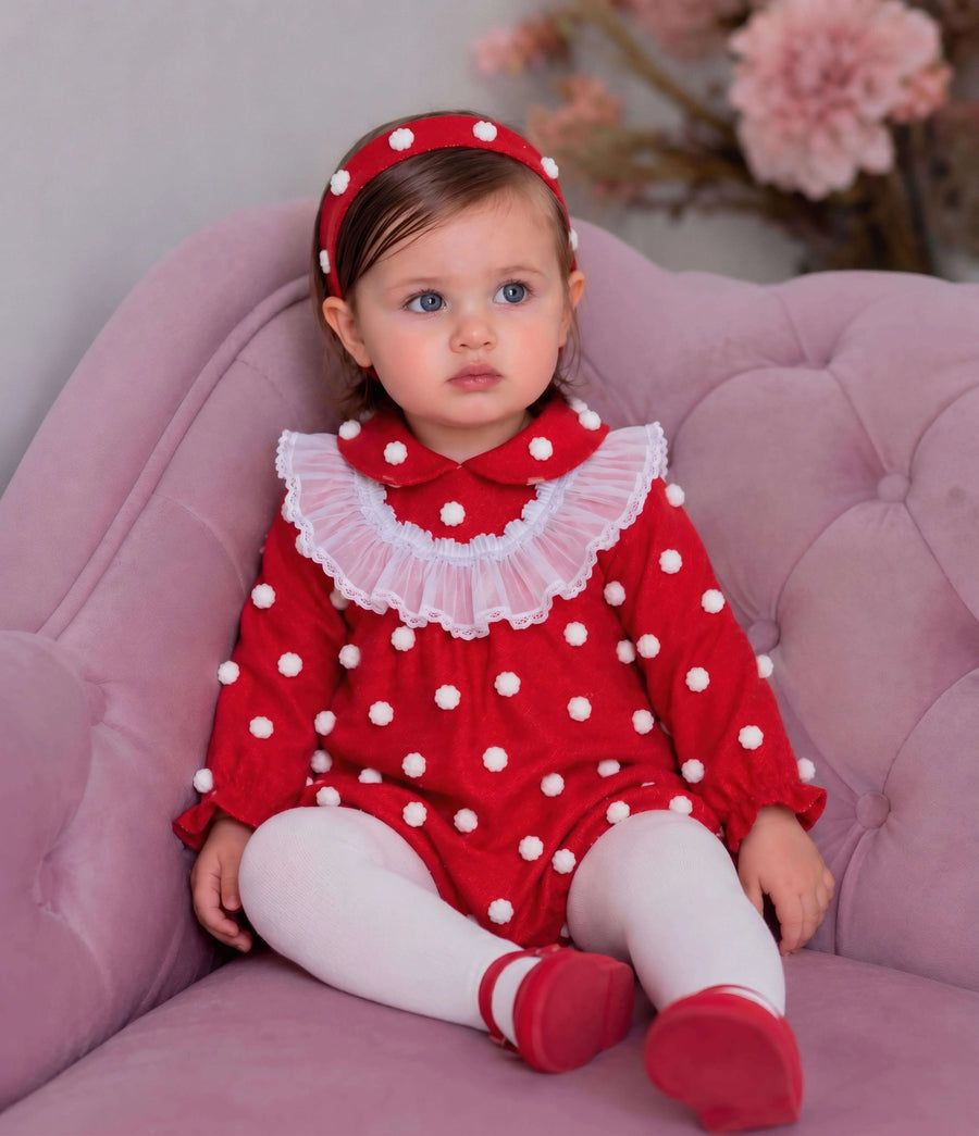 AW26 Rochy Baby Girls Red 3D Textured Spot Romper with rounded collar and sheer ruffle bib, available in sizes 3 months to 4 years.