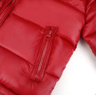 Close-up of shiny red puffer jacket with quilted stitching and vertical zipper pocket