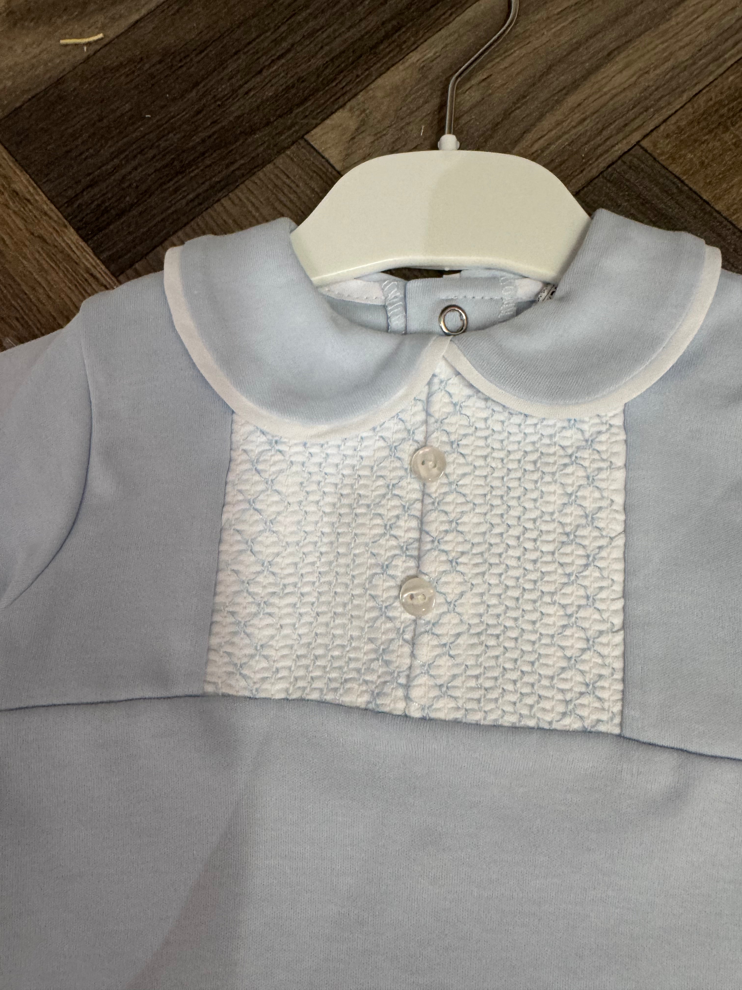 Light blue baby outfit with white embroidered front panel, pearl buttons, and Peter Pan collar on hanger