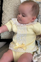 Baby girl in dainty lemon yellow knit lace jam pant set with white lace collar and bow
