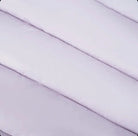 Close-up of textured, padded white fabric with horizontal stitched lines