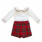 White long-sleeve baby shirt with scalloped collar and red trim paired with red plaid shorts