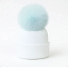White knit winter beanie hat with large light blue fluffy pom pom on top