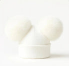 White knit beanie hat with two large fluffy pom-poms on a white background