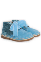 Pair of blue toddler boots with glitter heel and suede finish on white background