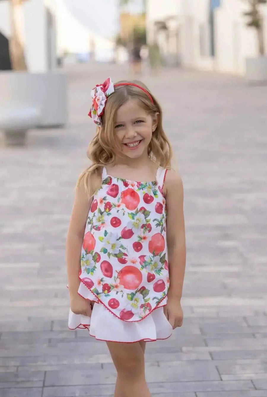 SS26 Miranda Girls Red Fruit A Line Dress featuring a vibrant fruit print, sleeveless design, and flared A-line silhouette. Sizes available: 2 Years, 3 Years, 4 Years, 5 Years, 6 Years, 8 Years.
