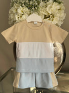 Color block baby boy summer outfit with beige, white, and light blue short sleeve shirt and matching shorts