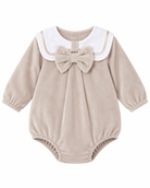 Baby girls’ beige velour romper with white sailor collar, beige piping, oversized matching bow and long sleeves on a white background.