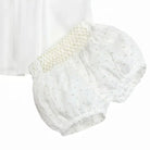 White plumetis baby shorts with gold smocked waistband and elastic leg openings