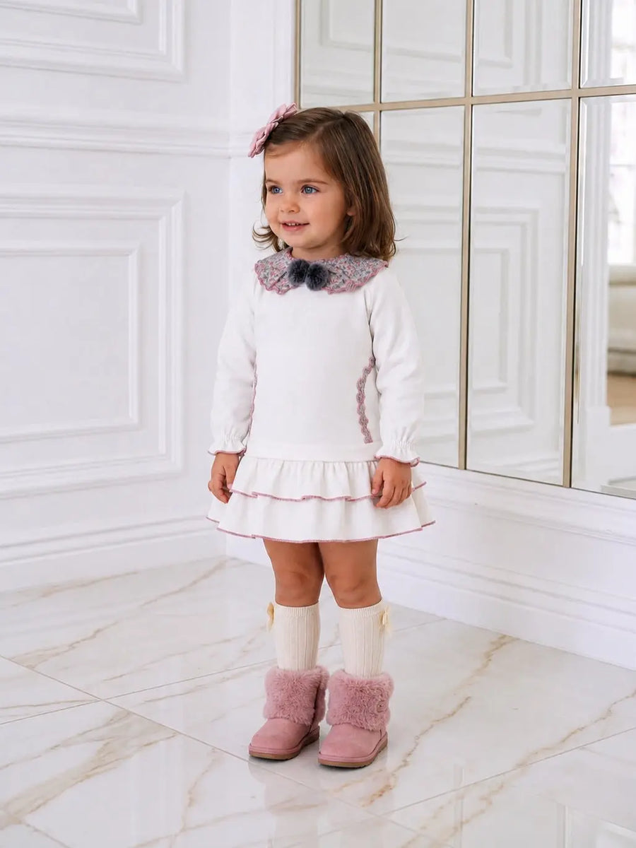 AW26 Miranda Girls White Floral Frill Dress featuring a scalloped collar and frill hem, available in sizes 2-8 years.