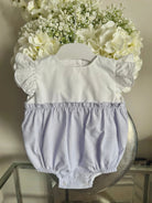 Baby romper with white lace flutter sleeves and lilac striped bottom on a hanger with white flowers